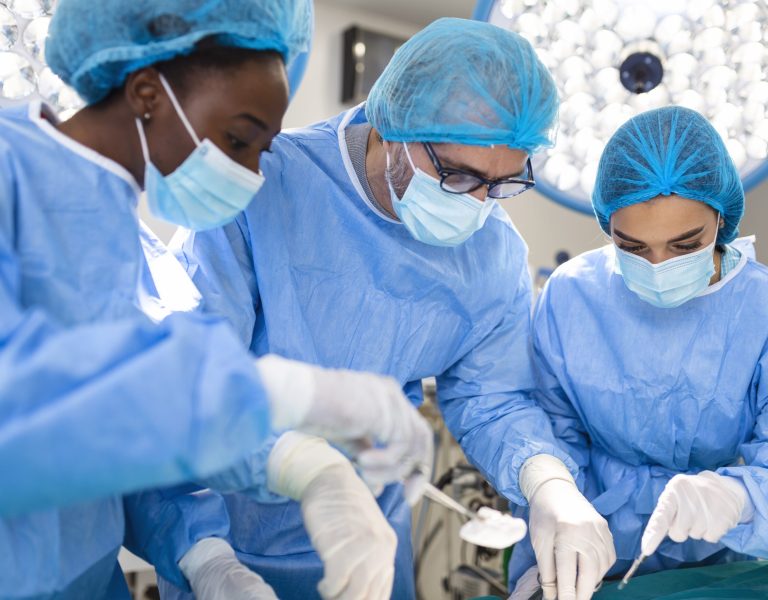 Surgeon team in uniform performs an operation on a patient at a cardiac surgery clinic. Modern medicine, a professional team of surgeons, health.